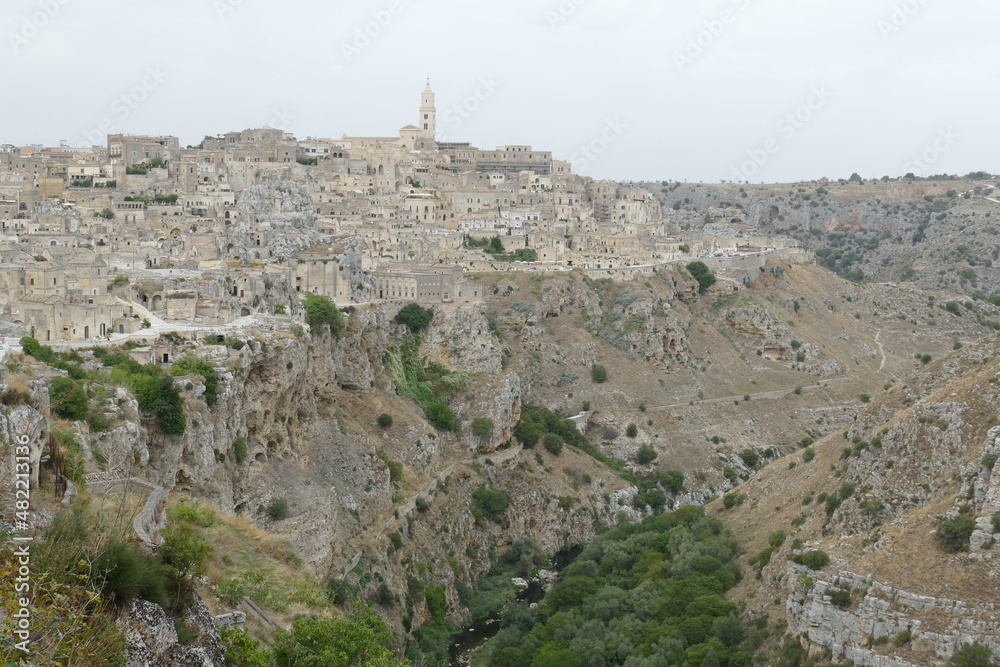 panorama of Sasso Caveoso in Matera with typical rupestrian churches excavated inside the rock on the canyon carved by the Gravina River