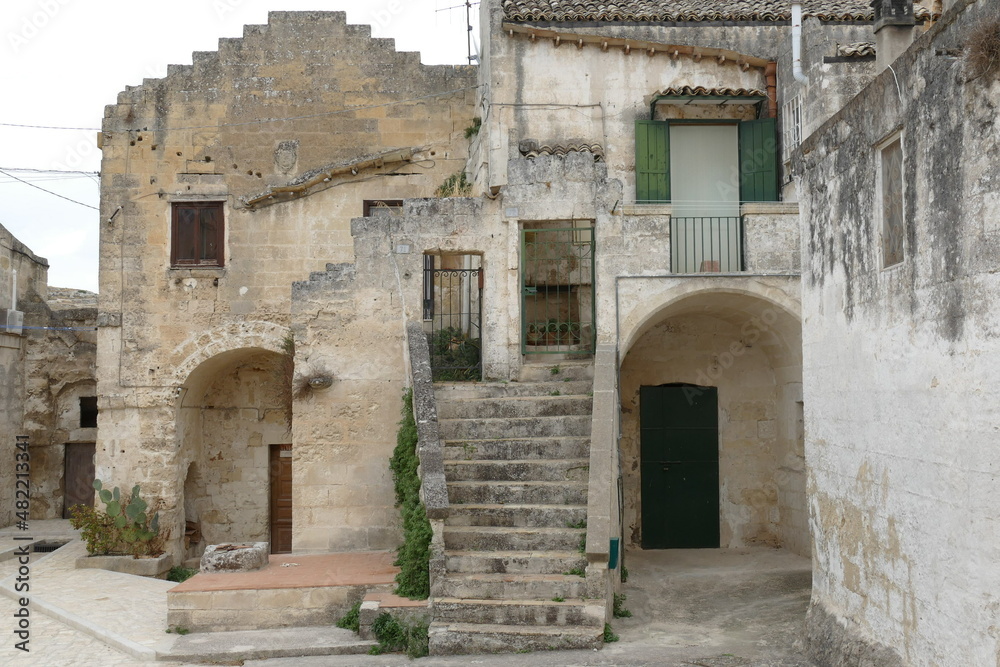 typical street of Sasso Caveoso in Matera with the facade of rupestrian houses built by white sandstone