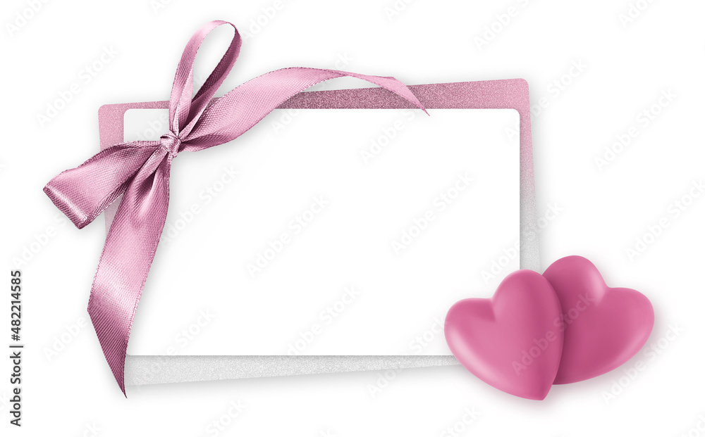 Mothers day gift card, white ticket for copy space with pink shiny ribbon bow and little hearts isolated on white background, top view and also for women's day or greetings card