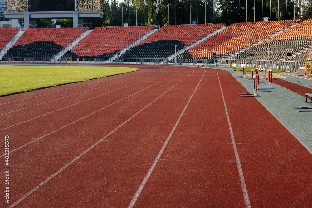 Fototapeta premium Running tracks close-up at the stadium during sunset. Sports facilities for running. Sport.