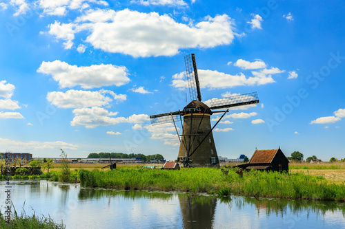 Dutch windmill on river bank, Kinderdijk, Holland © tselykh