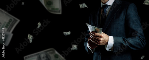 Money stack. Business man hand holding American money. Washington cash, usd falling banner.