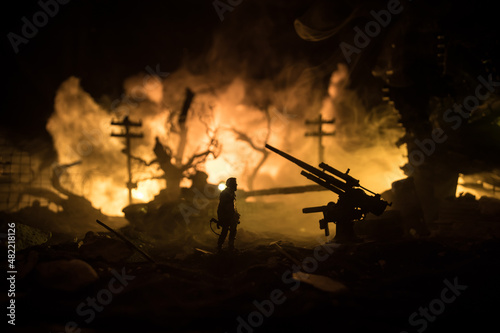 War Concept. Military silhouettes fighting scene on war fog sky background, World War Soldiers Silhouette Below Cloudy Skyline At night. Battle in ruined city.