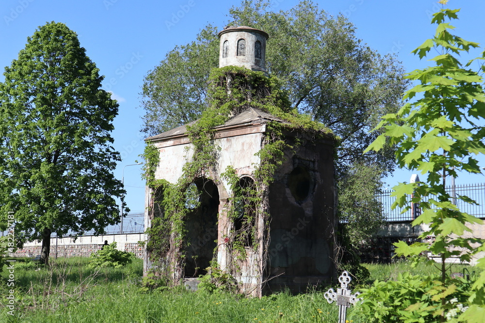 Fototapeta premium Old crypt at the Nikolsky cemetery of the Alexander Nevsky Lavra in Saint Petersburg, Russia. Burial place was founded in 1861, now is active and freely accessible at the present time.