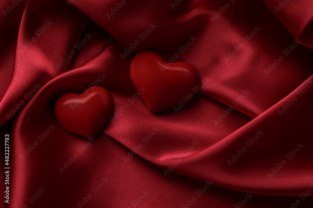 Two red hearts on a silk background, Valentine's day concept. Two red hearts on a silk background, Valentine's day concept.