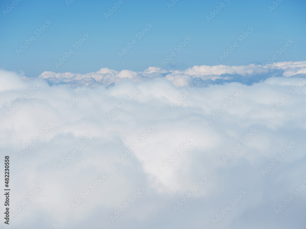 Aerial view. The drone flies over foggy and fluffy clouds. Blue sky sun and sea fog. Abstract aerial nature summer ocean sunset sea and sky background. Vacation, vacation and holiday concept Aerial view. The drone flies over foggy and fluffy clouds. Blue sky sun and sea fog. Abstract aerial nature summer ocean sunset sea and sky background. Vacation, vacation and holiday concept