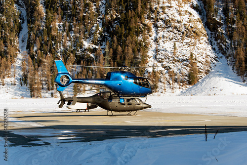 Two helicopters landing at St Moritz airport