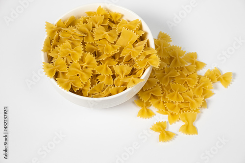 Close up of several types of dry pasta in a plate on white background photo