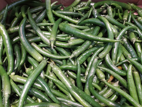 pods of hot green pepper in a pile