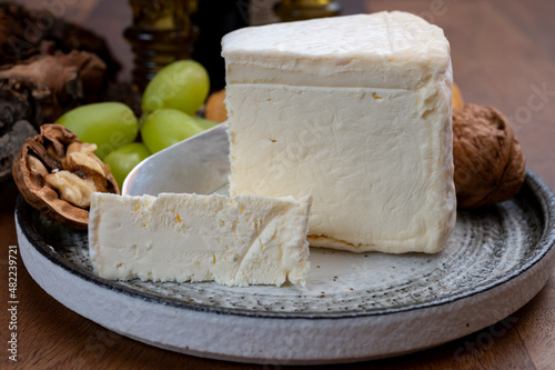Delice de Bourgogne French cow's milk cheese from Burgundy region of France served with grapes, wine and walnuts
