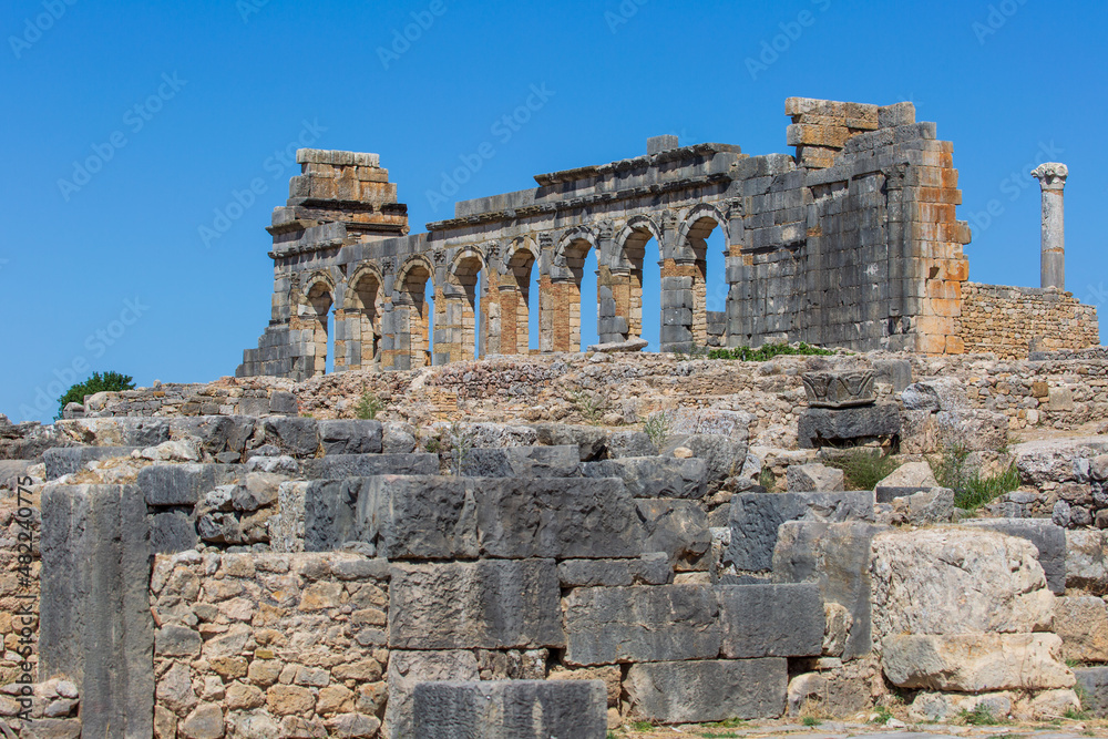 The large facade of an ancient building in Volubilis hints at the grandeur of old Moroccan culture