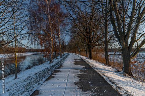 Asphalt path for bikes near Ceske Budejovice city in winter snowy morning