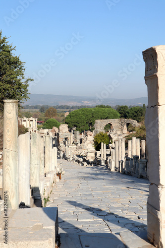 view to the ruins of the ancient city Ephesus - curetes street and library of Celsus on the background photo