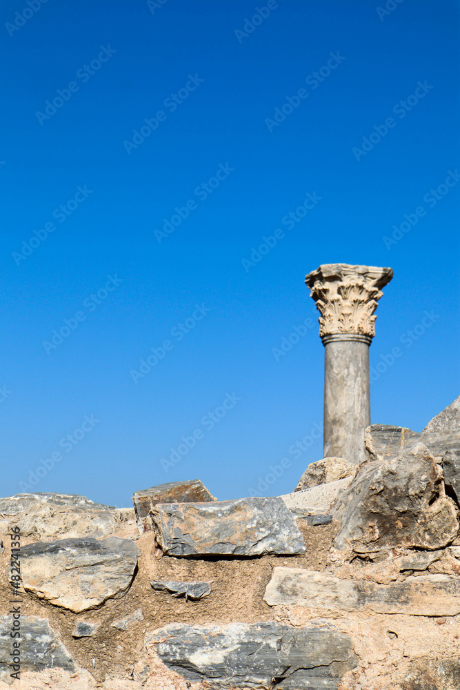 ruins of ancient temple - top of the column against blue sky