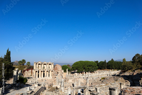scenic view to the ruins of library of celsus in acient city Ephesus in Turkey under blue sky