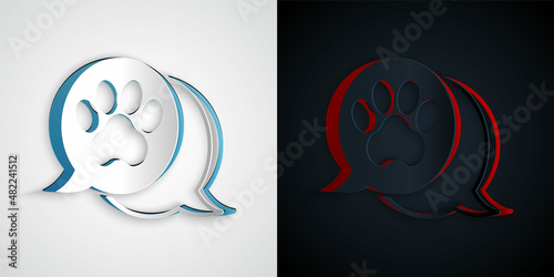 Paper cut Paw print icon isolated on grey and black background. Dog or cat paw print. Animal track. Paper art style. Vector