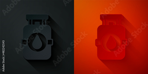 Paper cut Propane gas tank icon isolated on black and red background. Flammable gas tank icon. Paper art style. Vector