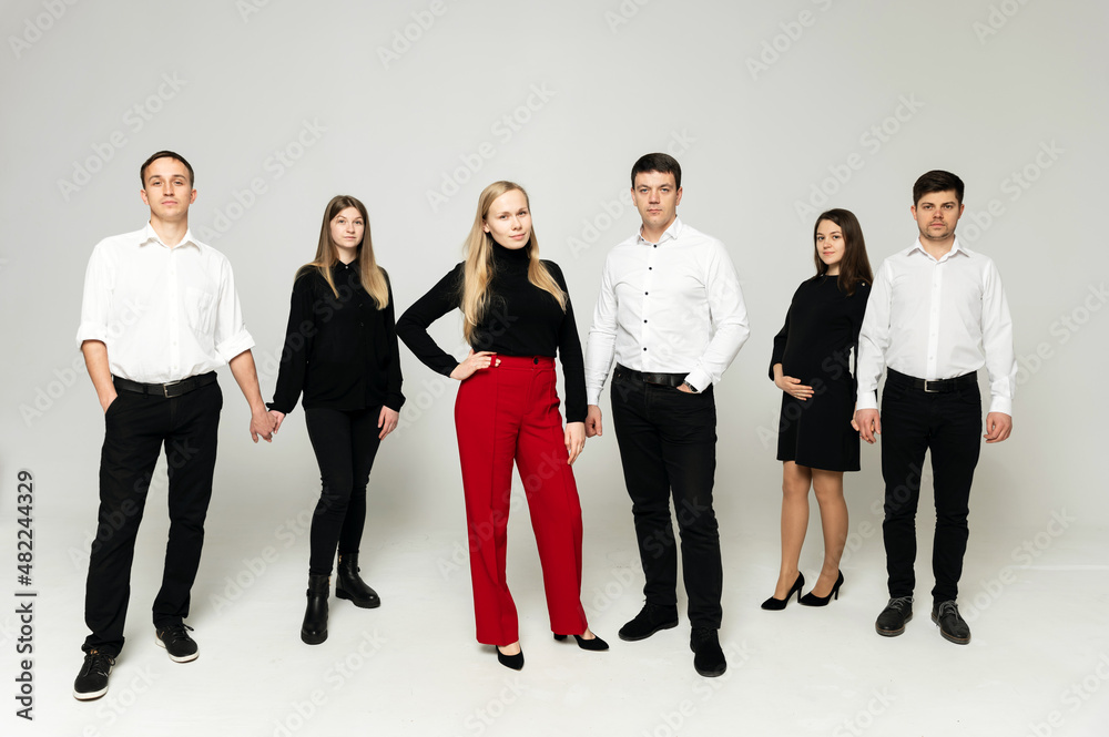 Obraz premium group of young people on a white background. brothers and sisters. company of friends in formal wear on a white background