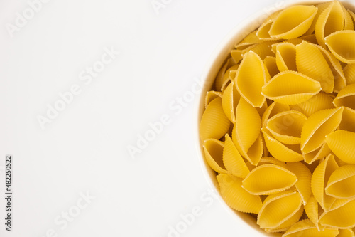 Close up of several types of dry pasta in a plate on white background photo