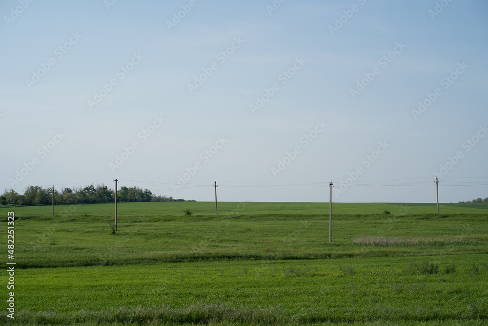 nature four pillars of the electric grid green meadow landscape blue sky