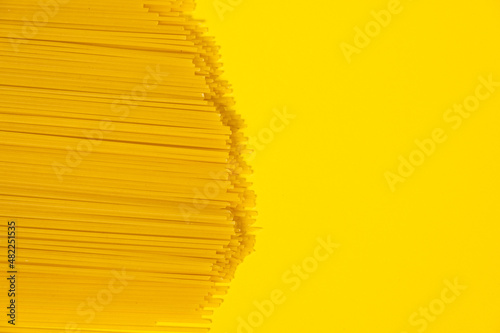 raw spaghetti italian food macro on yellow background