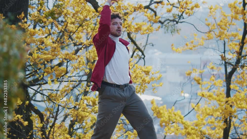 Handsome skillful young man actively dancing charismatic moves enjoying the music rhythm. Professional contemporary dancer. Handsome skillful young man actively dancing charismatic moves enjoying the music rhythm. Professional contemporary dancer.