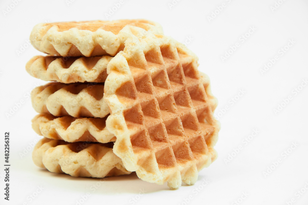 Belgian waffles on a table. holiday cookies on a white background. fresh baking concept. sweet desserts on a light texture Belgian waffles on a table. holiday cookies on a white background. fresh baking concept. sweet desserts on a light texture