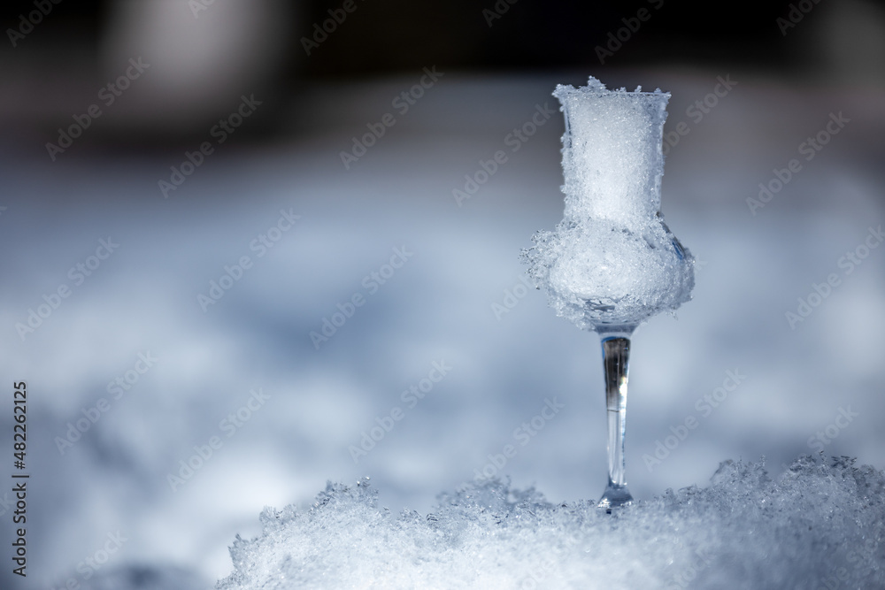 Flavored Grappa (Schnapps) glass filled with snow in Cortina d'Ampezzo, Dolomites, Italy Flavored Grappa (Schnapps) glass filled with snow in Cortina d'Ampezzo, Dolomites, Italy