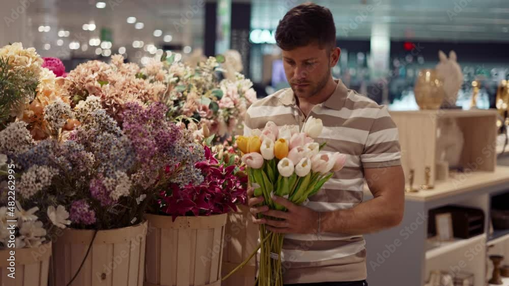 Man choosing flowers in floral shop Man choosing flowers in floral shop