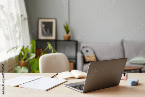 Background of home education workplace with laptop in foreground  copy space