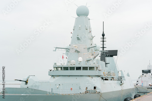 Warship with many locators gun turret have arrived in harbour. Naval. Defence. Protection. Army. Control