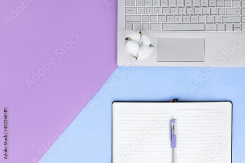 flat lay of a laptop, notebook on blue and purple background. Education online concept with copy space photo