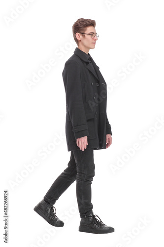Fashion shot of a young man in black coat on white background