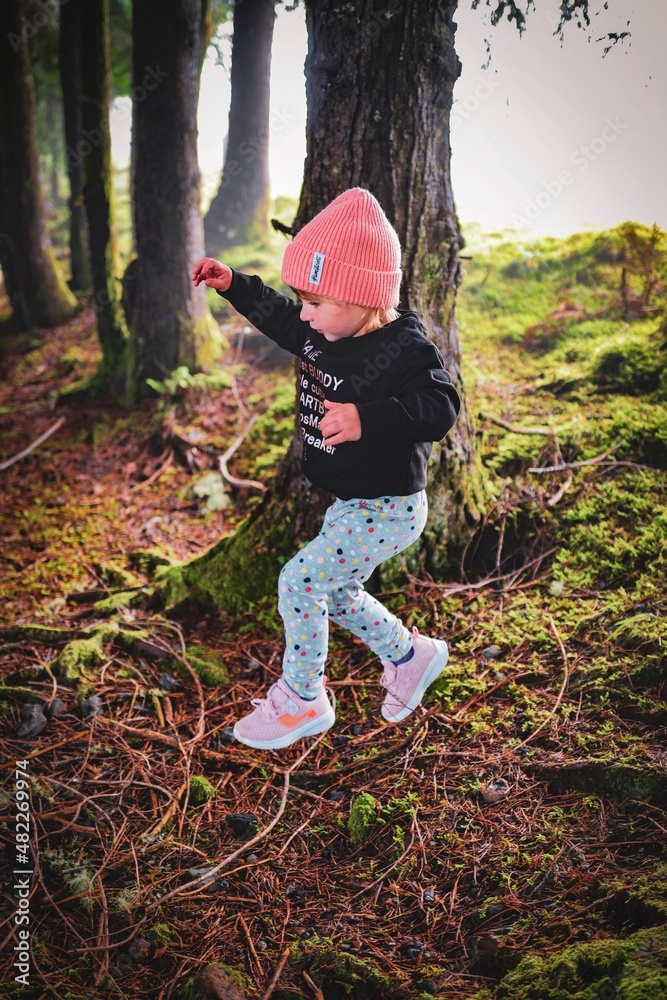 child playing in the forest child playing in the forest