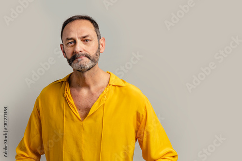 Stylish senior man peeking through sunglasses
