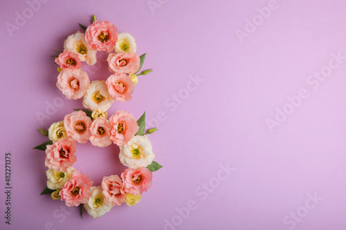 Flowers in the shape of number 8 on a colored background with place for text