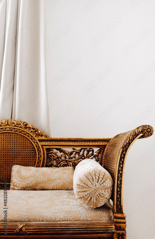 Antique arabic egyptian interior with gilded sofa and round tube pillow