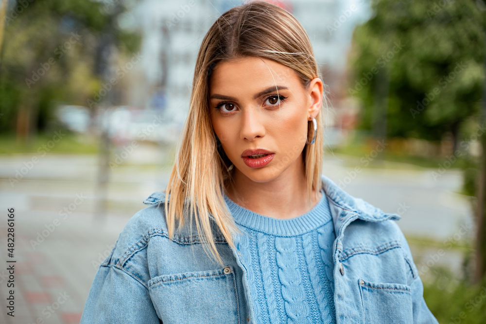 Attractive young woman in her twenties, posing outdoors fashion beauty style photo, looking at camera. Stunning natural woman Attractive young woman in her twenties, posing outdoors fashion beauty style photo, looking at camera. Stunning natural woman