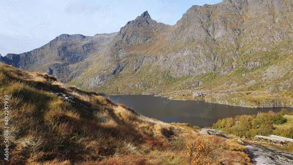 Blue lake in front of rugged mountains in Nord Norway. A i Lofoten Blue lake in front of rugged mountains in Nord Norway. A i Lofoten
