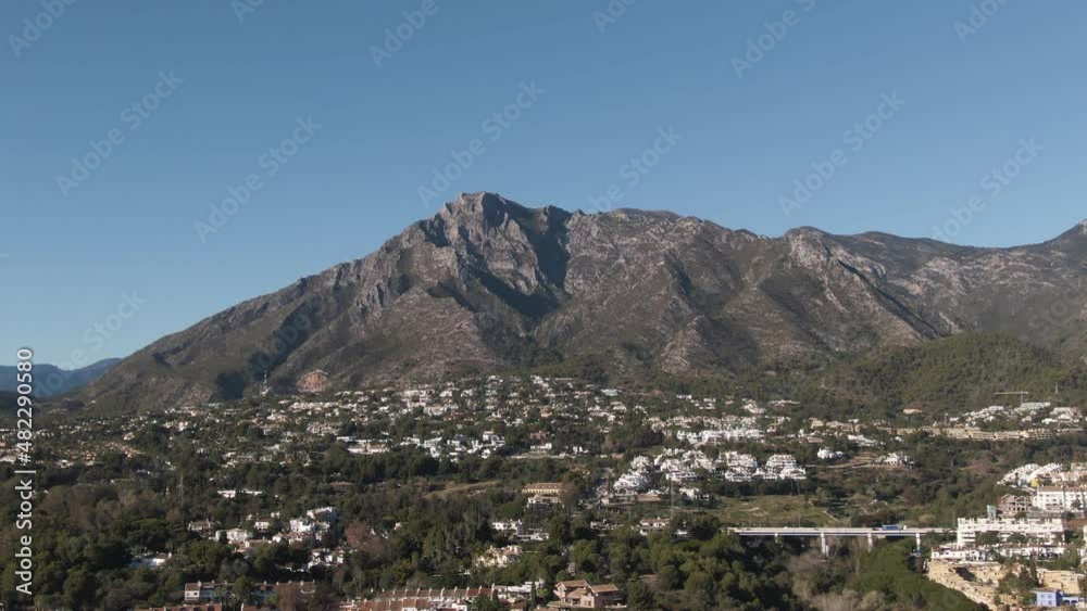 White buildings of Marbella with majestic mountain La Concha behind, aerial drone shot White buildings of Marbella with majestic mountain La Concha behind, aerial drone shot