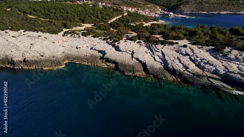 Drone zoom in shot of a tropical Mediterranean town located on an island on the Rukavac, Island Vis, Croatia during the Corona Pandemic.Amazing shot of the rocks and the sea, natural landscape 4K UHD