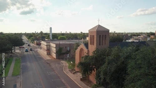 AERIAL - A small church on a small street in McAllen, Texas, wide forward shot photo