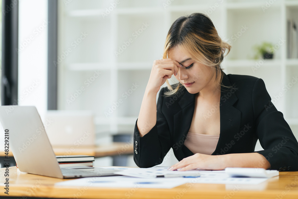 Frustrated Asian businesswoman cover her face with two hand and feel upset from work in front of laptop computer on desk at office,Stress office lifestyle concept Frustrated Asian businesswoman cover her face with two hand and feel upset from work in front of laptop computer on desk at office,Stress office lifestyle concept