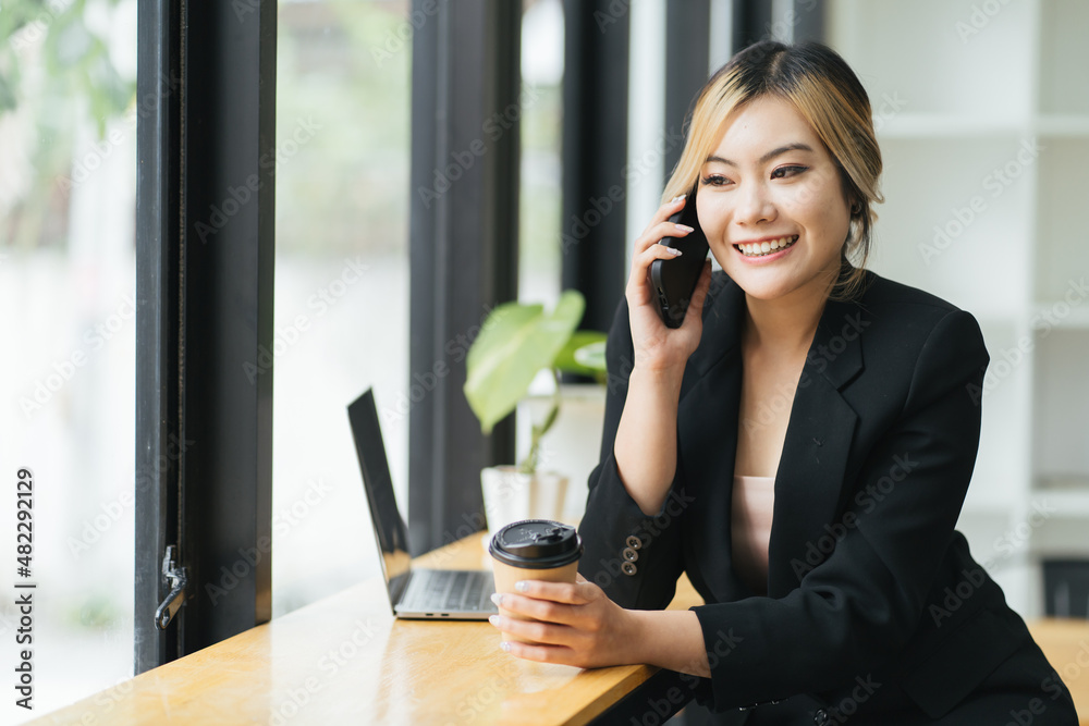 Beautiful young asian woman talking phone and smile in the coffee shop, business woman sitting in cafe free time, freelancer female calling telephone, communication concept. Beautiful young asian woman talking phone and smile in the coffee shop, business woman sitting in cafe free time, freelancer female calling telephone, communication concept.
