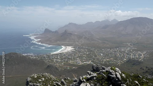 Wide shot. Spectacular late morning views from Hangklip hiking trail summit of Pringle Bay, the Atlantic Ocean and the Hottentots-Holland Mountain range in Cape Town South Africa. photo