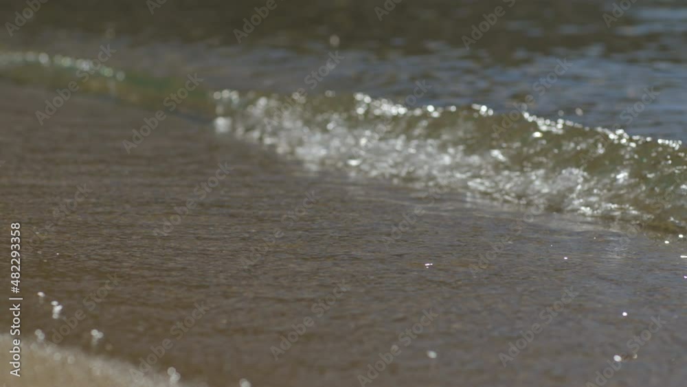 Gentle waves washing up on the shore in slow motion. Gentle waves washing up on the shore in slow motion.