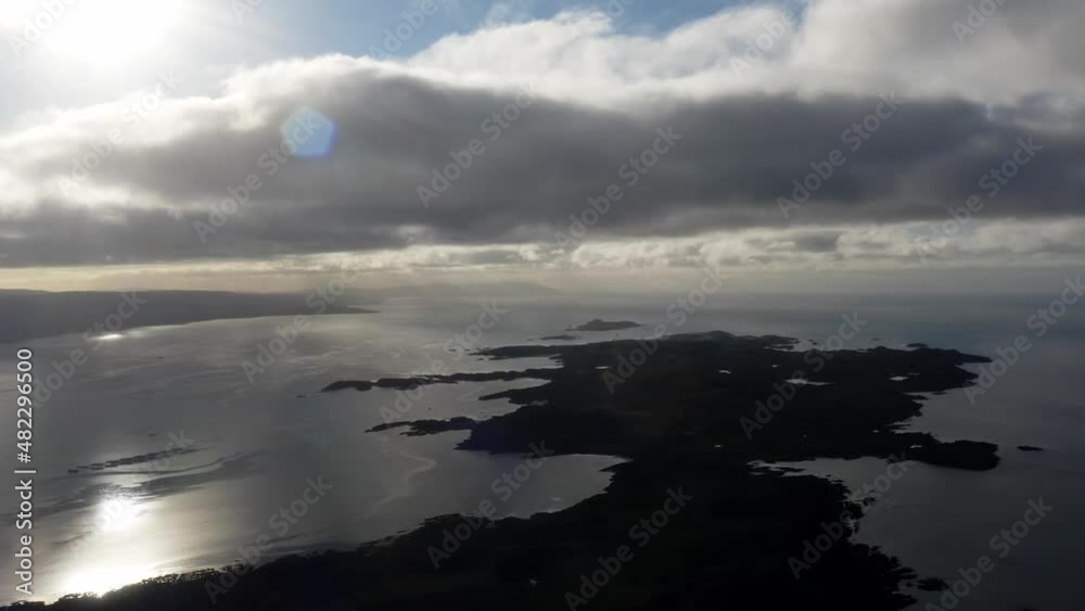 AERIAL - Silhouette of the Isle of Gigha at sunrise, Kintyre, Scotland, forward AERIAL - Silhouette of the Isle of Gigha at sunrise, Kintyre, Scotland, forward