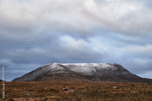 Errigal mountain. County Donegal. snowy peak in winter with cloudy sky and beautiful colors