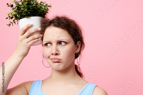 cheerful woman holding a flowerpot in her hands close-up unaltered