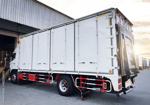 Cargo Trucks Parking at The Warehouse. Slider Lift for Loading Truck. Shipping Cargo Container. Lorry Loading. Industry Freight Truck Logistics Cargo Transport. 